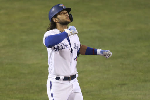 Toronto Blue Jays' Bo Bichette celebrates his three-run homer against Tampa Bay Rays pitcher Aaron loup during the sixth inning of a baseball game, Friday, Aug. 14, 2020, in Buffalo, N.Y. (AP Photo/Jeffrey T. Barnes)