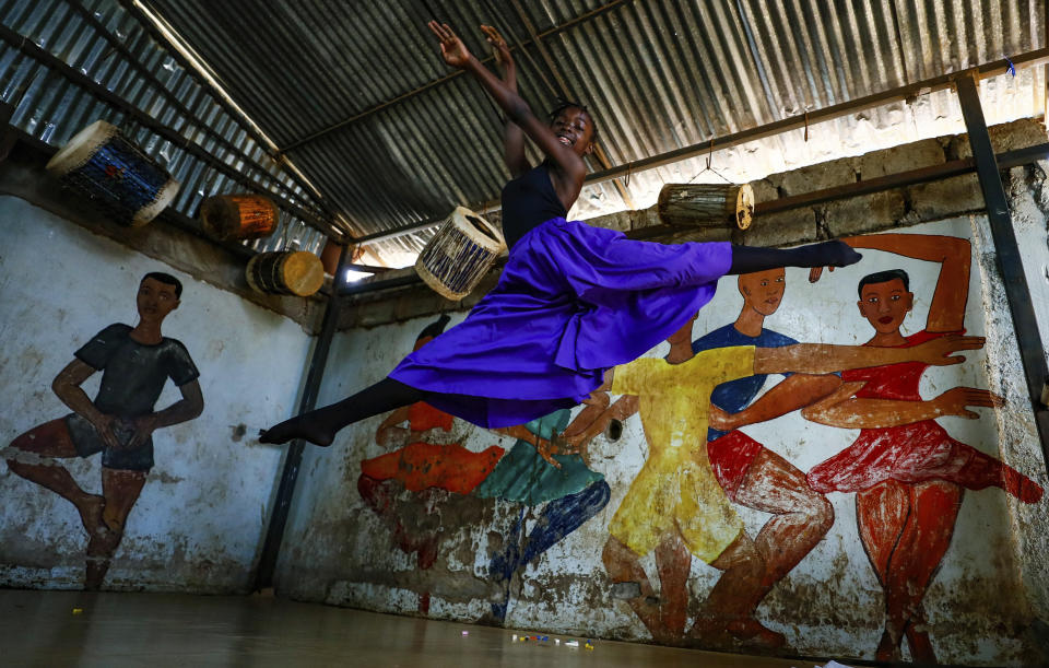 A young dancer performs at Project Elimu social hall, prior to the start of a Christmas ballet event in Kibera, one of the busiest neighborhoods of Kenya's capital, Nairobi, Friday, Dec. 15, 2023. The ballet project is run by Project Elimu, a community-driven nonprofit that offers after-school arts education and a safe space to children in Kibera. (AP Photo/Brian Inganga)