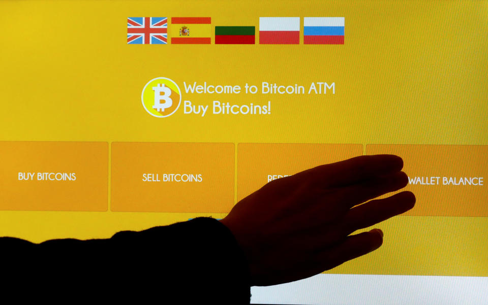 A man touches a screen of a bitcoin ATM in Vilnius, Lithuania December 6, 2017. REUTERS/Ints Kalnins