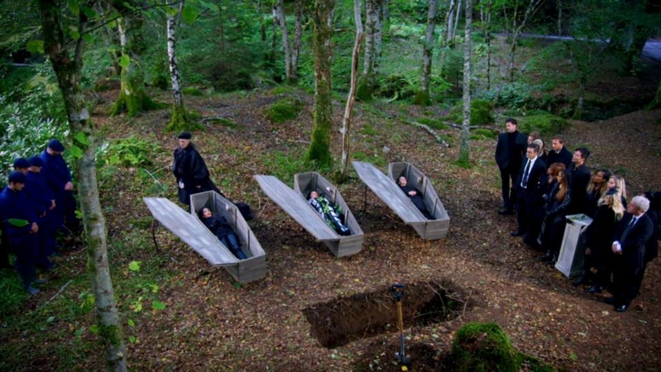 Ekin-Su, MJ, and Parvati lay in coffins waiting to hear who was murdered on "The Traitors" as their houseguests attend their fake funeral.