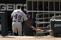 Detroit Tigers' Willi Castro (49) celebrates with manager Ron Gardenhire, right, in the dugout after scoring on a Jorge Bonifacio single during the first inning of a baseball game against the Chicago White Sox, Sunday, Sept. 13, 2020, in Chicago. (AP Photo/Paul Beaty)