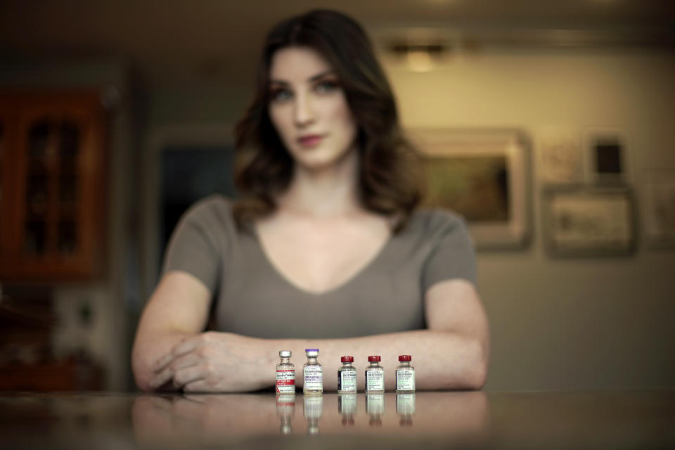 Transgender woman Stacy Cay displays some of the hormone therapy drugs she has stockpiled in fear of losing her supply, Thursday, April 20, 2023, at her home in Overland Park, Kan. (AP Photo/Charlie Riedel)