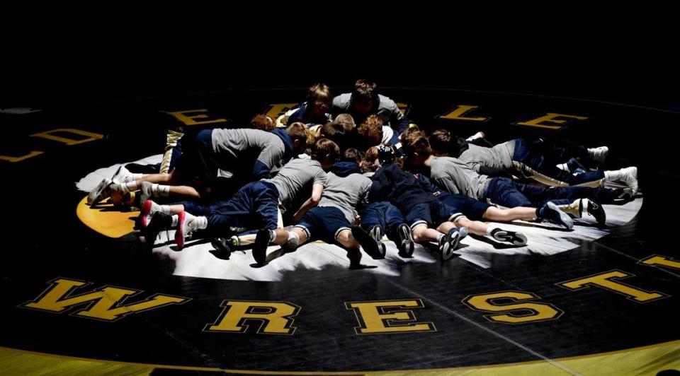 The Bald Eagle Area wrestling team piles the middle of the mat before their match against Quaker Valley on Monday, Feb. 5, 2024.