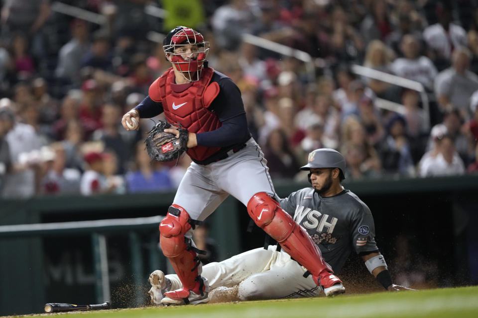 Cleveland Guardians catcher Mike Zunino looks to throw to first after forcing out Washington Nationals' Keibert Ruiz during the fourth inning of a baseball game in Washington, Friday, April 14, 2023. (AP Photo/Manuel Balce Ceneta)