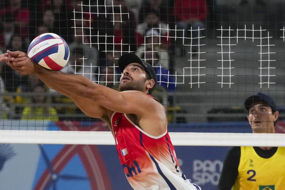 Chile's Marco Grimalt returns the ball during a men's beach volleyball semifinal match against Brazil at the Pan American Games in Santiago, Chile, Thursday, Oct. 26, 2023. (AP Photo/Esteban Felix)