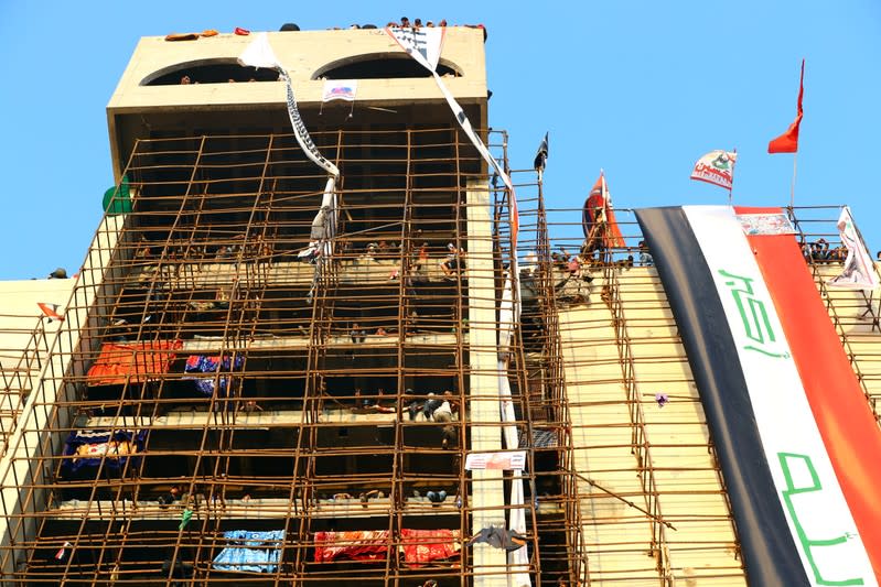 Iraqi demonstrators are seen inside the high-rise building, called by Iraqi the Turkish Restaurant Building, during anti-government protests in Baghdad