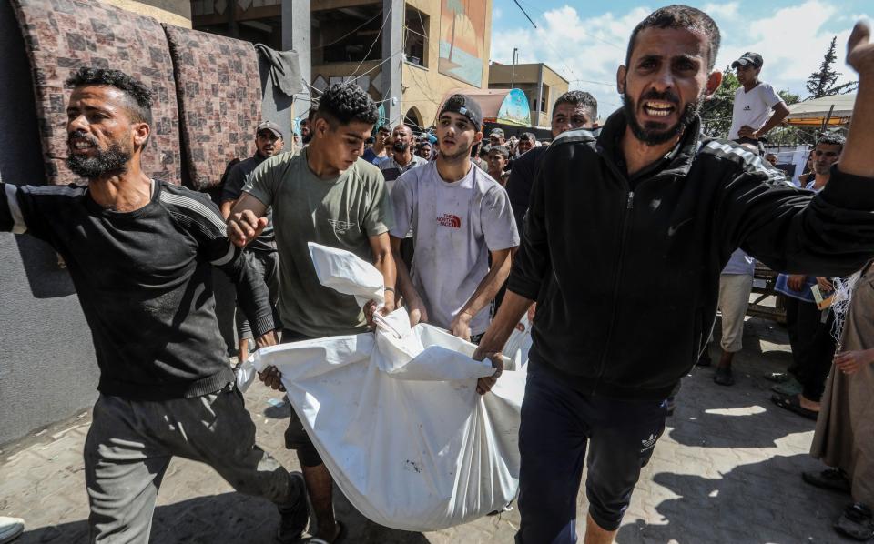 The body of a Palestinian is pulled from the rubble after the Israeli attack in Deir al-Balah.