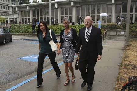 Bart and Leslie Tichelman join hands with their daughter, Monica, after attending the arraignment of their daughter, Alix Catherine Tichelman in Santa Cruz, California July 16, 2014. REUTERS/Robert Galbraith