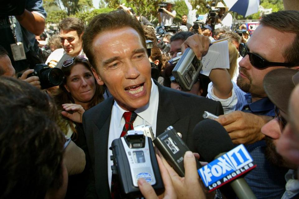 Arnold Schwarzenegger talks to reporters as he leaves the Los Angeles county registrar’s office carrying the papers needed to run for governor, in 2003.