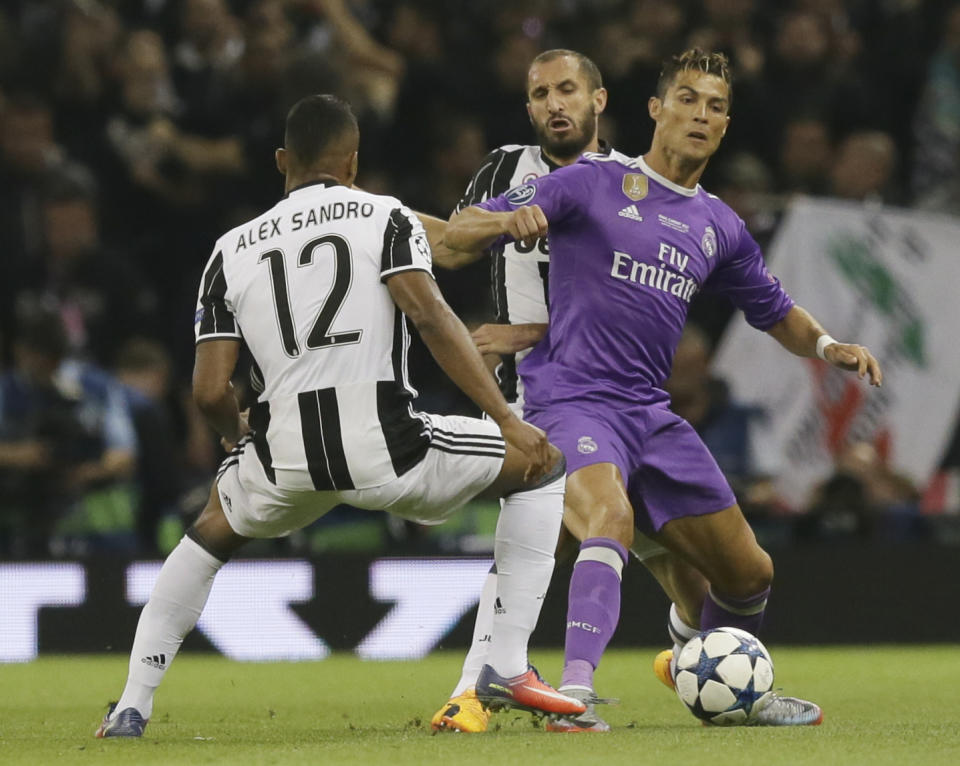 <p>Real Madrid’s Cristiano Ronaldo, right, challenges for the ball with Juventus’ Alex Sandro during the Champions League final soccer match between Juventus and Real Madrid at the Millennium Stadium in Cardiff, Wales, Saturday June 3, 2017. (AP Photo/Tim Ireland) </p>