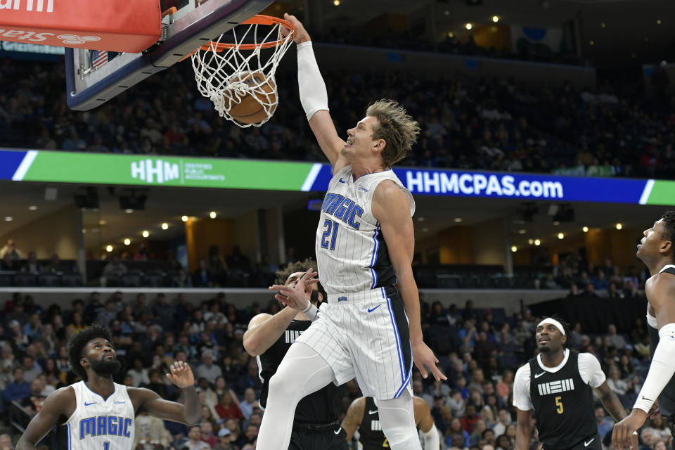 Orlando Magic center Moritz Wagner (21) dunks against Memphis Grizzlies forward David Roddy, center bottom, in the first half of an NBA basketball game Friday, Jan. 26, 2024, in Memphis, Tenn. (AP Photo/Brandon Dill)