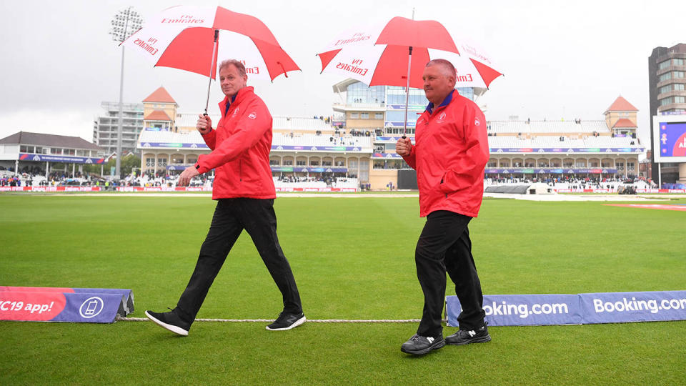 Umpires Paul Reiffel and Marais Erasmus walk back to the Pavilion after calling off the match. (Photo by Laurence Griffiths/Getty Images)