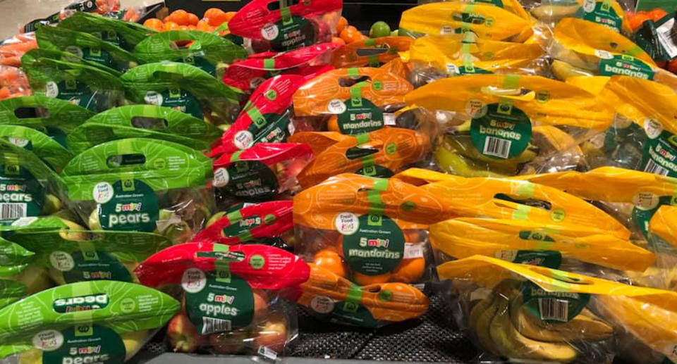 Photo from inside a Melbourne Woolworths store of mini fruit packaged inside plastic carry bags.