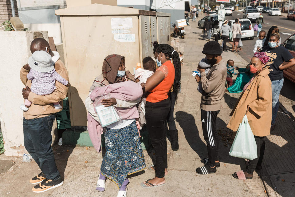 Image: A long queue of people wanting basic food and baby items at the Legends Diner organized by Muslims For Humanity in Durban, South Africa (Rajesh Jantilal / AFP - Getty Images)