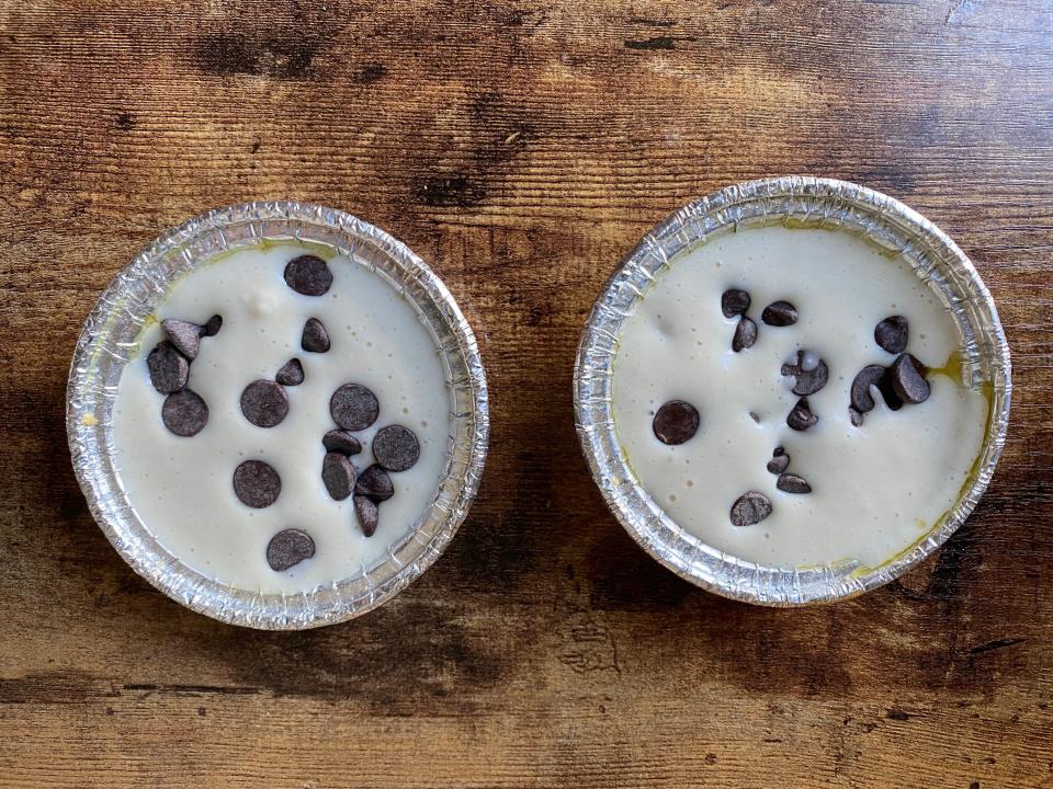 The pancake batter in the tin cups filled with chocolate chips