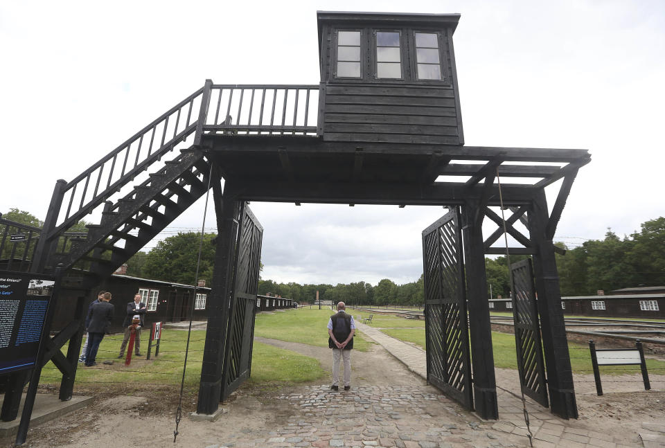 FILE - In this July 18, 2017 file photo, the wooden main gate leads into the former Nazi German Stutthof concentration camp in Sztutowo, Poland. A 97-year-old woman charged with being an accessory to murder for her role as secretary to the SS commander of the Stutthof concentration camp during World War II. (AP Photo/Czarek Sokolowski, file)