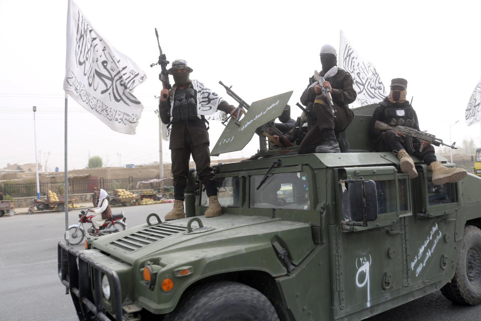 Taliban fighters patrol on the road during a celebration marking the second anniversary of the withdrawal of U.S.-led troops from Afghanistan, in Kandahar, south of Kabul, Afghanistan, Tuesday, Aug. 15, 2023. (AP Photo/Abdul Khaliq)