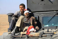 <p>A wounded displaced man is seen atop a vehicle during a battle with Islamic State militants, in the district of Maamoun in western Mosul, Iraq, Feb. 23, 2017. (Alaa Al-Marjani/Reuters) </p>