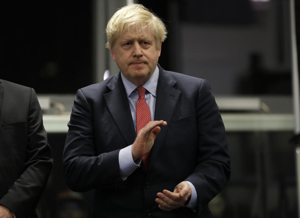 Britain's Prime Minister and Conservative Party leader Boris Johnson applauds during the Uxbridge and South Ruislip constituency count declaration at Brunel University in Uxbridge, London, Friday, Dec. 13, 2019. (AP Photo/Kirsty Wigglesworth)