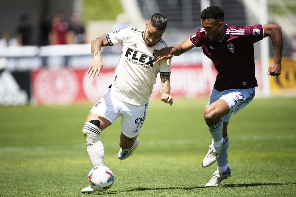 Los Angeles FC forward Cristian Arango, left, drives past Colorado Rapids defender Auston Trusty in the first half of an MLS soccer match Saturday, May 14, 2022, in Commerce City, Colo. (AP Photo/David Zalubowski)