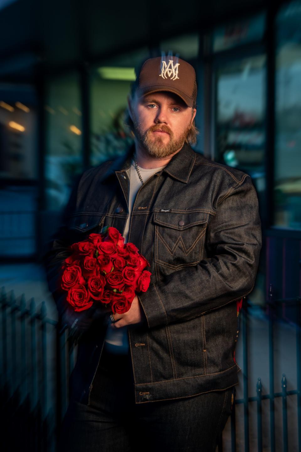 Country music artist Ernest Keith Smith, known as Ernest, poses at Flower Express in Nashville, Tenn., Monday, Jan. 23, 2023. Ernest has an upcoming deluxe album titled “Two Dozen Roses.”