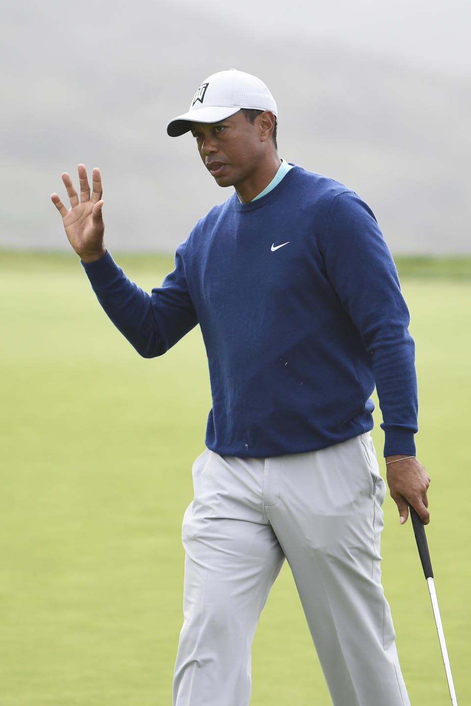 Tiger Woods waves after hitting a birdie putt on the third hole of the South Course at Torrey Pines Golf Course during the third round of the Farmers Insurance golf tournament Saturday Jan. 25, 2020, in San Diego. (AP Photo/Denis Poroy)