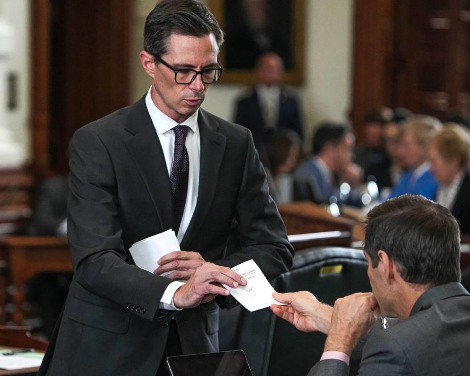 Texas Senate Sergeant-at-Arms Austin Osborn collects Sen. Nathan Johnson’s vote on Article 1 in the impeachment trial of Attorney General Ken Paxton at the Texas Capitol on Saturday, Sep. 16, 2023.