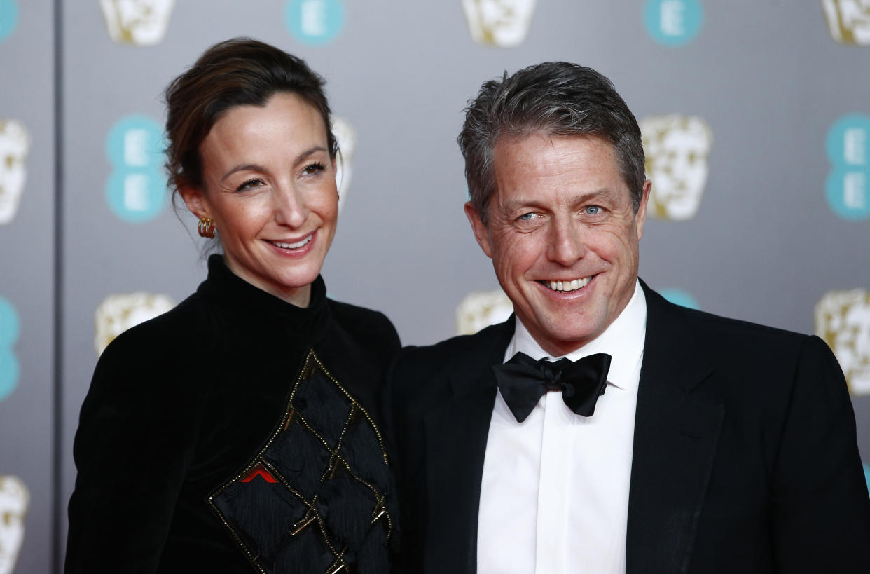 Anna Elisabet Eberstein and Hugh Grant arrives at the British Academy of Film and Television Awards (BAFTA) at the Royal Albert Hall in London, Britain, February 2, 2020. REUTERS/Henry Nicholls