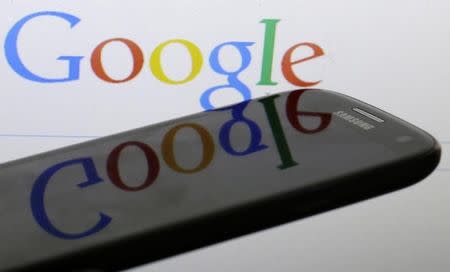 A Google logo is reflected on the screen of a Samsung Galaxy S4 smartphone in this photo illustration taken in Prague January 31, 2014. REUTERS/David W Cerny