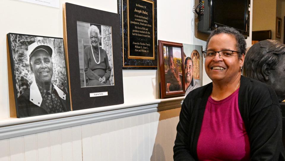 "The NAACP is still here," said Lynne Rhodes, president of the Cape Cod chapter. Rhodes, photographed Thursday at the Zion Union Heritage Museum in Hyannis, stands next to photos of past chapter presidents: (from left) Joseph DaLuz, Eugenia Fortes, Scoba Rhodes (her father) and John Reed.