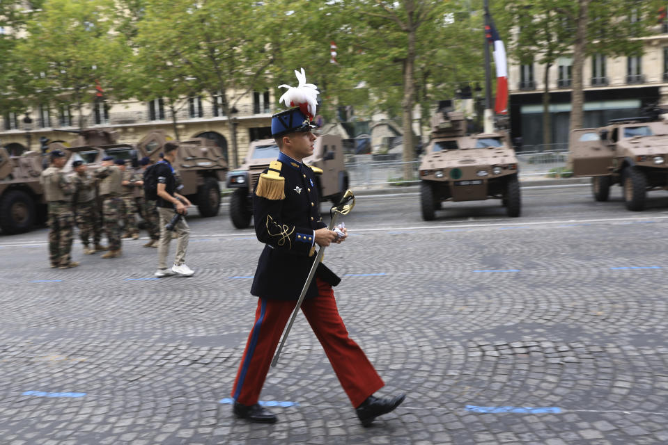 A cadet of the Saint-Cyr military school walks on the Champs-Elysees avenue before the Bastille Day military parade Friday, July 14, 2023 in Paris. Indian Prime Minister Narendra Modi will be the guest of honor at the annual Bastille Day parade. (AP Photo/Aurelien Morissard)