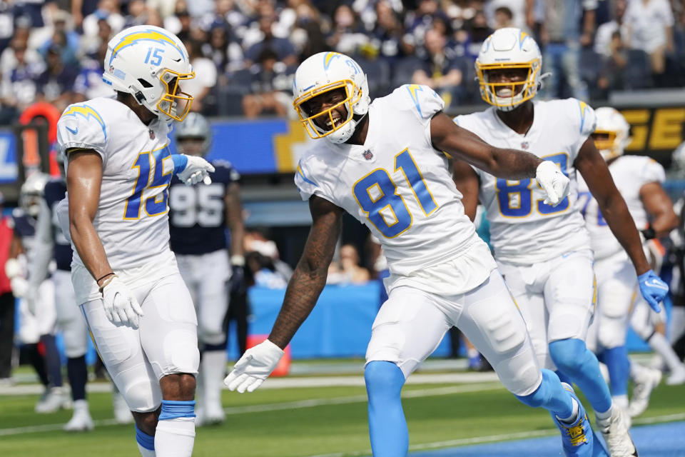 Los Angeles Chargers wide receiver Mike Williams (81) celebrates his touchdown catch with Jalen Guyton (15) during the first half of an NFL football game against the Dallas Cowboys Sunday, Sept. 19, 2021, in Inglewood, Calif. (AP Photo/Gregory Bull)