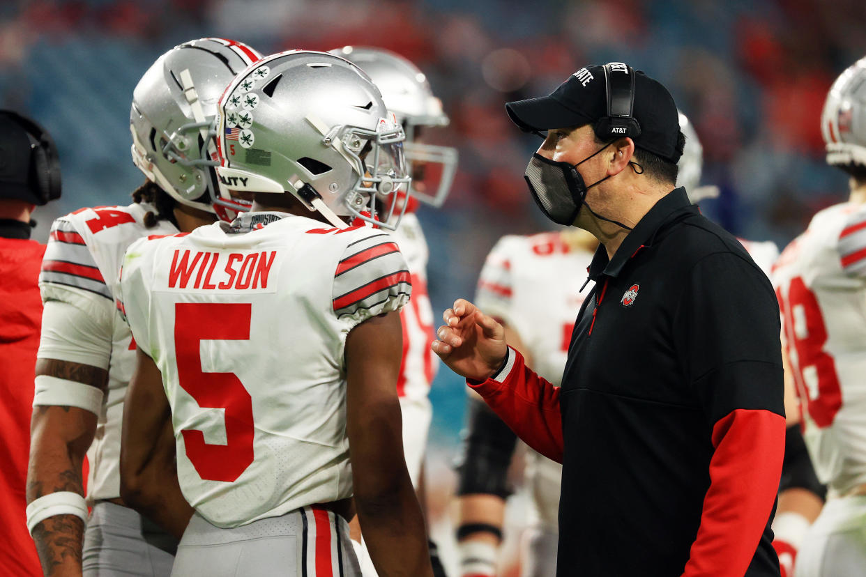 MIAMI GARDENS, FLORIDA - JANUARY 11: Head coach Ryan Day of the Ohio State Buckeyes talks with Garrett Wilson #5 against the Alabama Crimson Tide during the second quarter of the College Football Playoff National Championship game at Hard Rock Stadium on January 11, 2021 in Miami Gardens, Florida. (Photo by Mike Ehrmann/Getty Images)