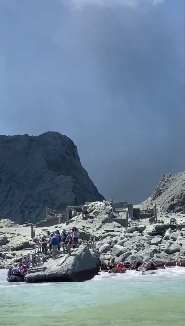 An image provided by visitor Michael Schade shows tourists and tour guides fleeing White Island as it erupts. Source: Michael Schade