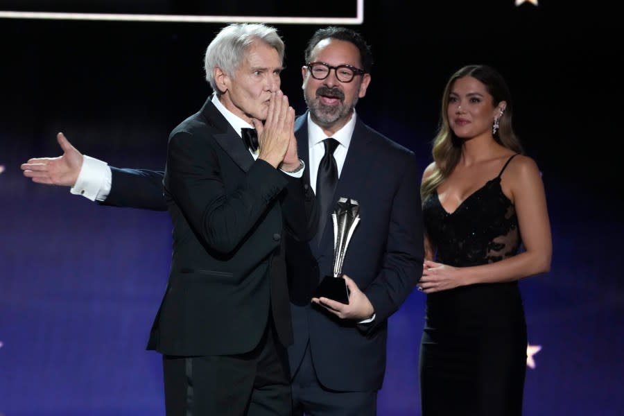 Harrison Ford, left, accepts the career achievement award from James Mangold during the 29th Critics Choice Awards on Sunday, Jan. 14, 2024, at the Barker Hangar in Santa Monica, Calif. (AP Photo/Chris Pizzello)