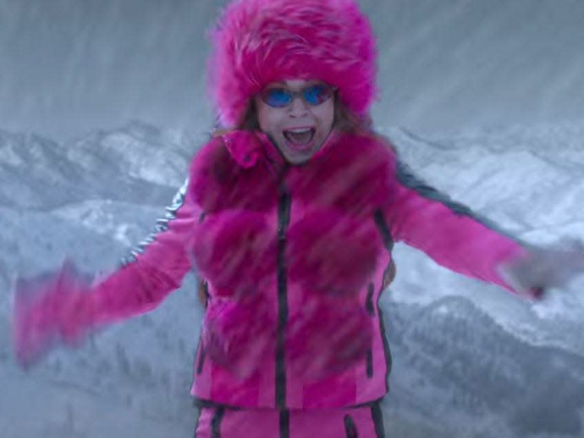 sierra falling off a mountain wearing a pink snowsuit in falling for christmas