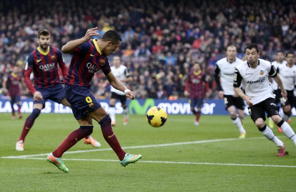 FC Barcelona's Alexis Sanchez, second left, kicks to the ball to score against Valencia during a Spanish La Liga soccer match at the Camp Nou stadium in Barcelona, Spain, Saturday, Feb. 1, 2014. (AP Photo/Manu Fernandez)