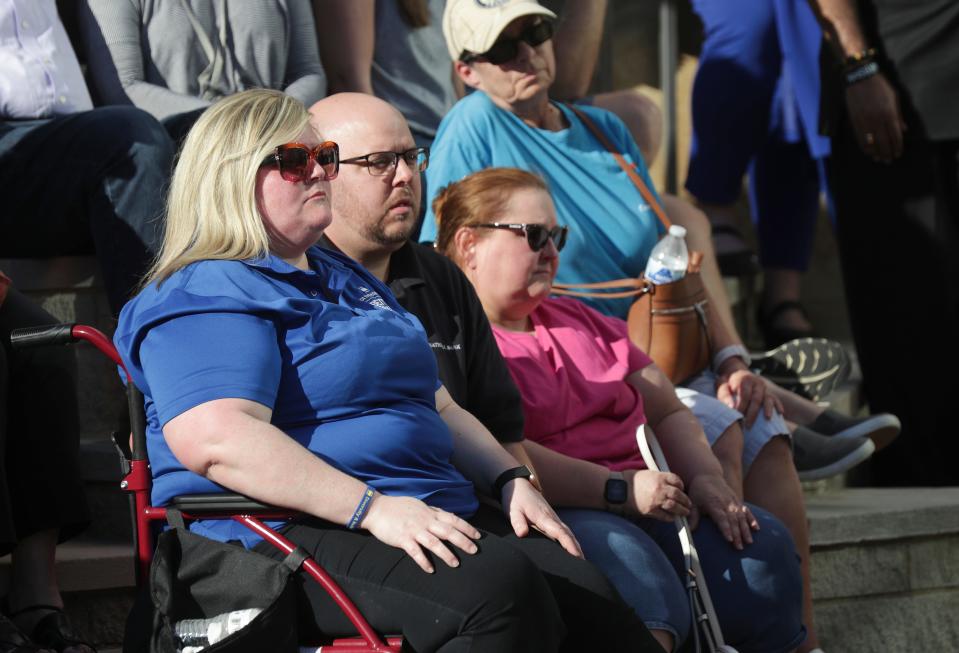 Old National Bank employee Emily Goodlett, left, and her husband Caleb Goodlett listened to speakers during a community vigil at the Ali Center to honor the victims of the mass shooting at the Old National Bank that occurred earlier in the week in Louisville, Ky. on Apr. 12, 2023.  Goodlett was working that day and was able to seek shelter in a vault.