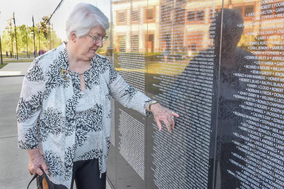 Zema Laird points to her husband’s name, Maj. Jerry Laird, on the new Dignity Memorial Vietnam Wall, which was dedicated March 29, 2024, at the National Infantry Museum in Columbus, Georgia.