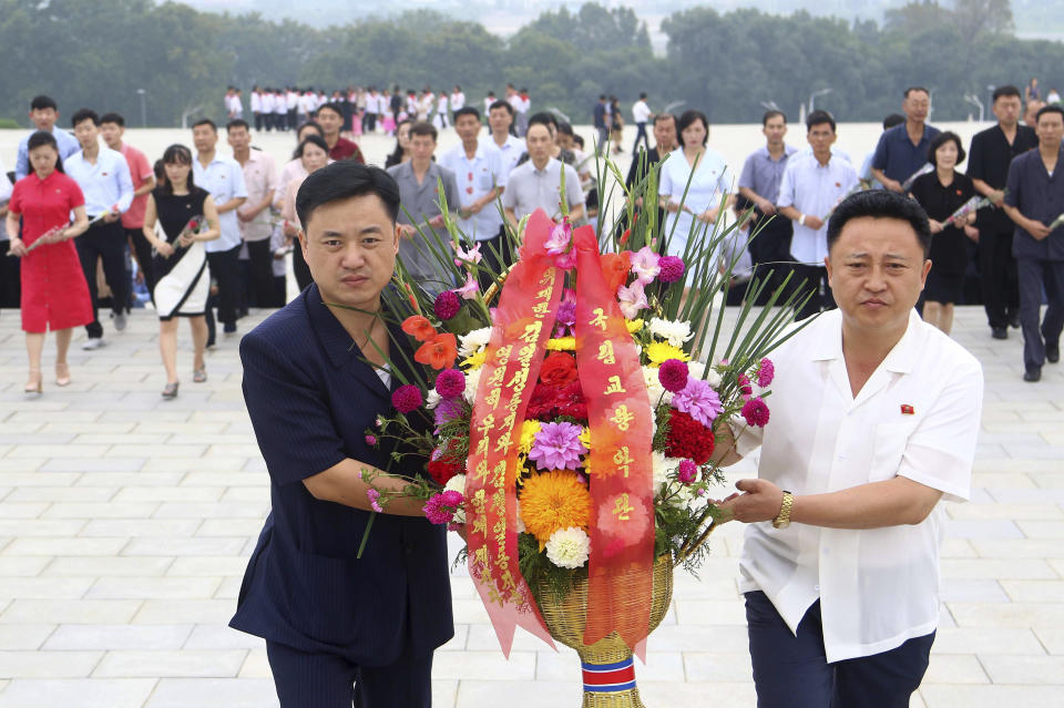 Children visit the statues of former leaders Kim Il Sung and Kim Jong Il on Mansu Hill in Pyongyang, marking North Korea’s 75th founding anniversary, on Saturday, Sept. 9, 2023. (AP Photo/Jon Chol Jin)