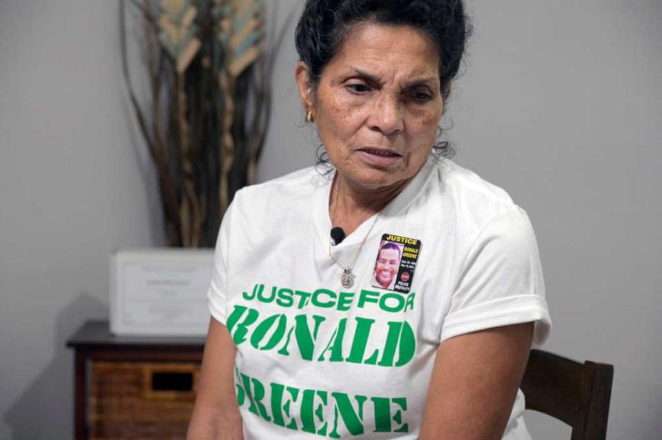 Mona Hardin relives the events surrounding the death of her son, Ronald Greene, as his boxed ashes sit behind her on a table on Dec. 4, 2021, in Orlando, Florida. (Photo: Phelan M. Ebenhack/AP)