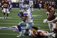 FILE - In this Dec. 15, 2019, file photo, Dallas Cowboys wide receiver Amari Cooper (19) pulls down a reception over Washington Redskins cornerback Jimmy Moreland (32) to help set up a touchdown during the first half of an NFL football game in Arlington, Texas. A person with knowledge of the deal says the Cowboys and top receiver Cooper have agreed on a long-term contract. (AP Photo/Ron Jenkins, File)