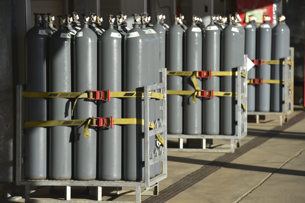 Gray nitrogen containers, arrayed on pallets.