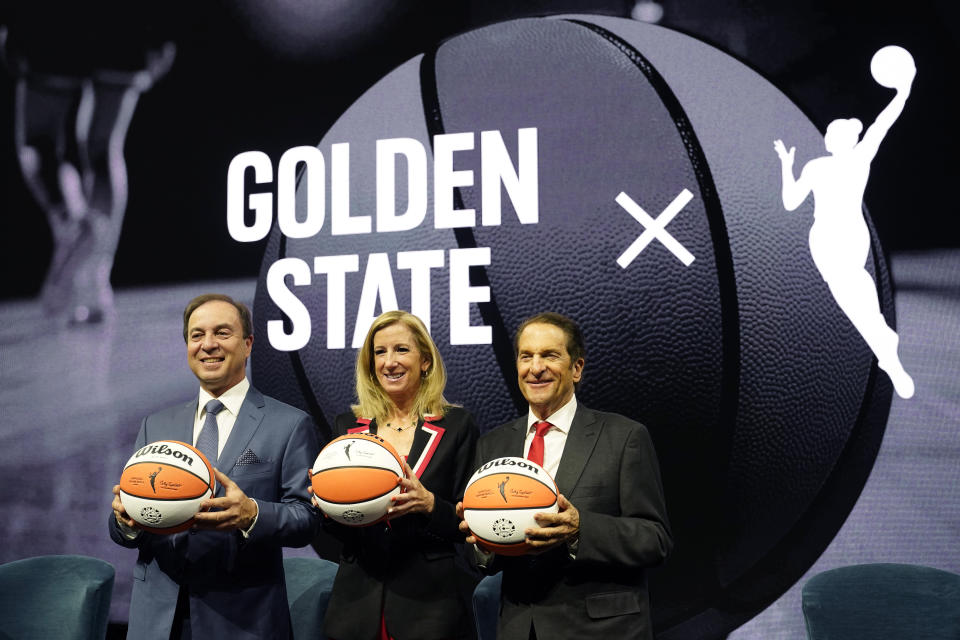 Golden State Warriors CEO Joe Lacob, WNBA commissioner Cathy Engelbert and Warriors co-executive chairman Peter Guber pose on Thursday during the WNBA expansion announcement that the San Francisco Bay Area team will begin play in the 2025 season. (AP Photo/Eric Risberg)