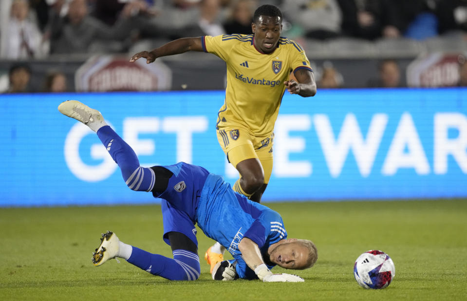 Colorado Rapids goalkeeper William Yarbrough, front, tumbles to the pitch after stopping a shot by Real Salt Lake midfielder Anderson Julio in the second half of an MLS soccer match Saturday, May 20, 2023, in Commerce City, Colo. (AP Photo/David Zalubowski)