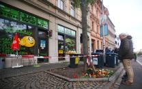 People are seen in front of a kebab shop in Halle