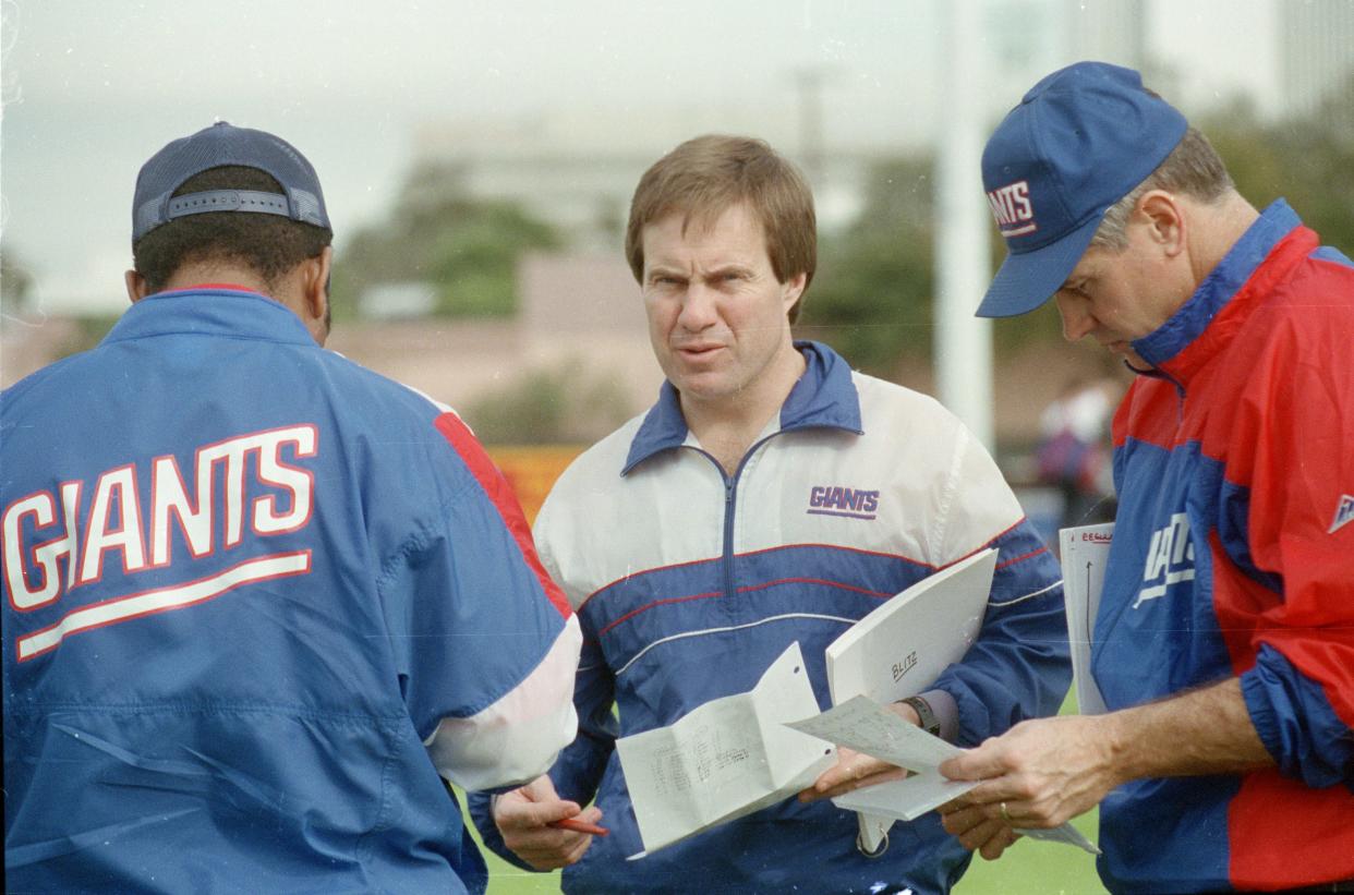 New York Giants defensive coordinator Bill Belichick, center, goes over the defensive game plan Jan. 23, 1991 with other coaches. Belichick and the Giants are getting ready for Super Bowl XXV against the Buffalo Bills in Tampa. (AP Photo)