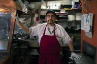 Edward Flores, 56, a fourth-generation owner of Juanita's Cafe on Olvera Street, stands for a photo in his restaurant in Los Angeles, Friday, June 4, 2021. Flores said he has gone deep into debt keeping Juanita's Café, a small food stand in his family for three generations, open. Business is down more than 87%, he said. In April, his best month during the pandemic, he had $3,100 in sales, but that pales in comparison to his rent of $3,625 — even though it was forgiven — not to mention utilities, insurance and property tax. On his worst day of the pandemic, he worked alone for 13 hours and recorded sales of $11.25. "I didn't have a doomsday thought. I just was just flabbergasted," he said. "I thought what an incredible waste of time." (AP Photo/Jae C. Hong)