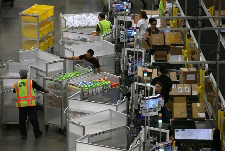 Amazon.com workers pack orders at an Amazon fulfillment center in Tracy, California