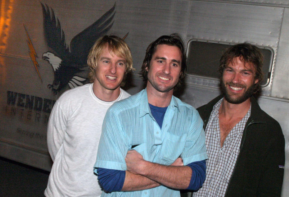 the 3 brothers posing outside of a trailer